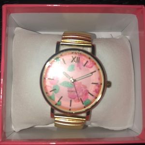 Gold watch with floral background